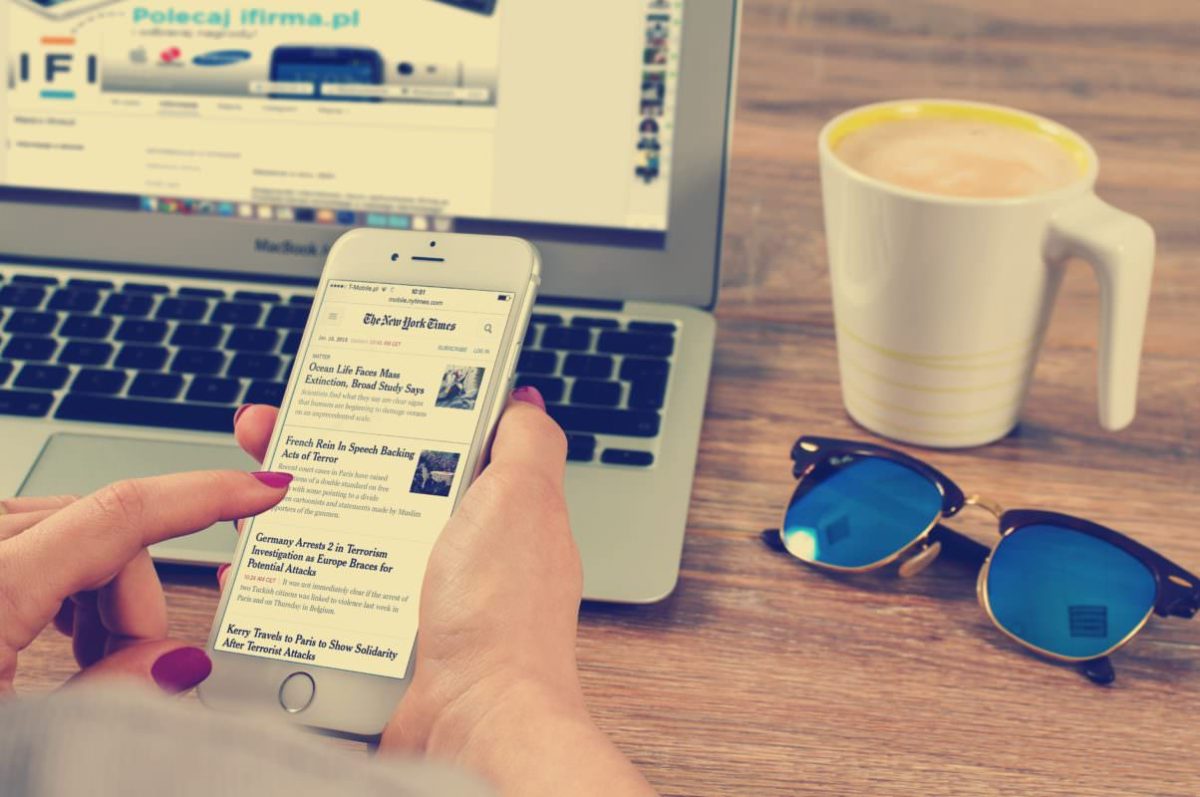 A woman scrolling through the New York Times on her smartphone